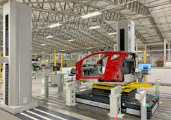 The Emira chassis, which remains on the AGV, is lowered into position and aligned ready for inspection by laser scanning. The Emira chassis, which remains on the AGV, is lowered into position and aligned ready for inspection by laser scanning.