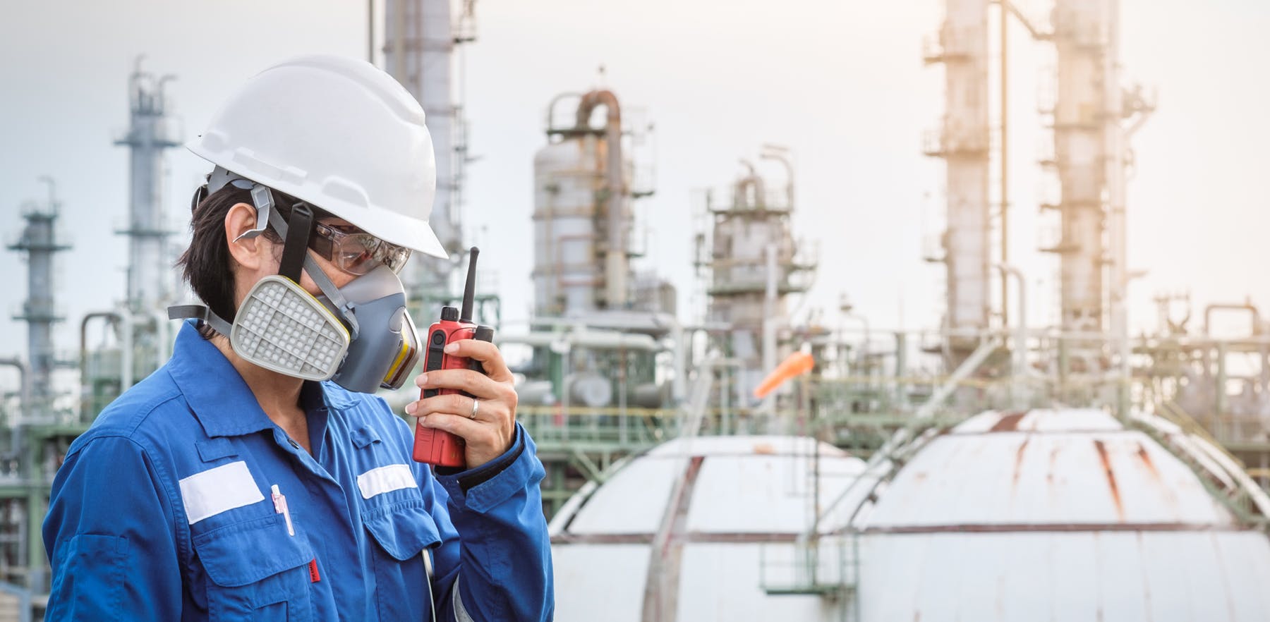 Chemical plant worker wearing respirator