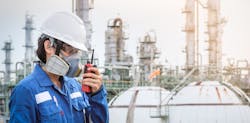Chemical plant worker wearing respirator Chemical plant worker wearing respirator