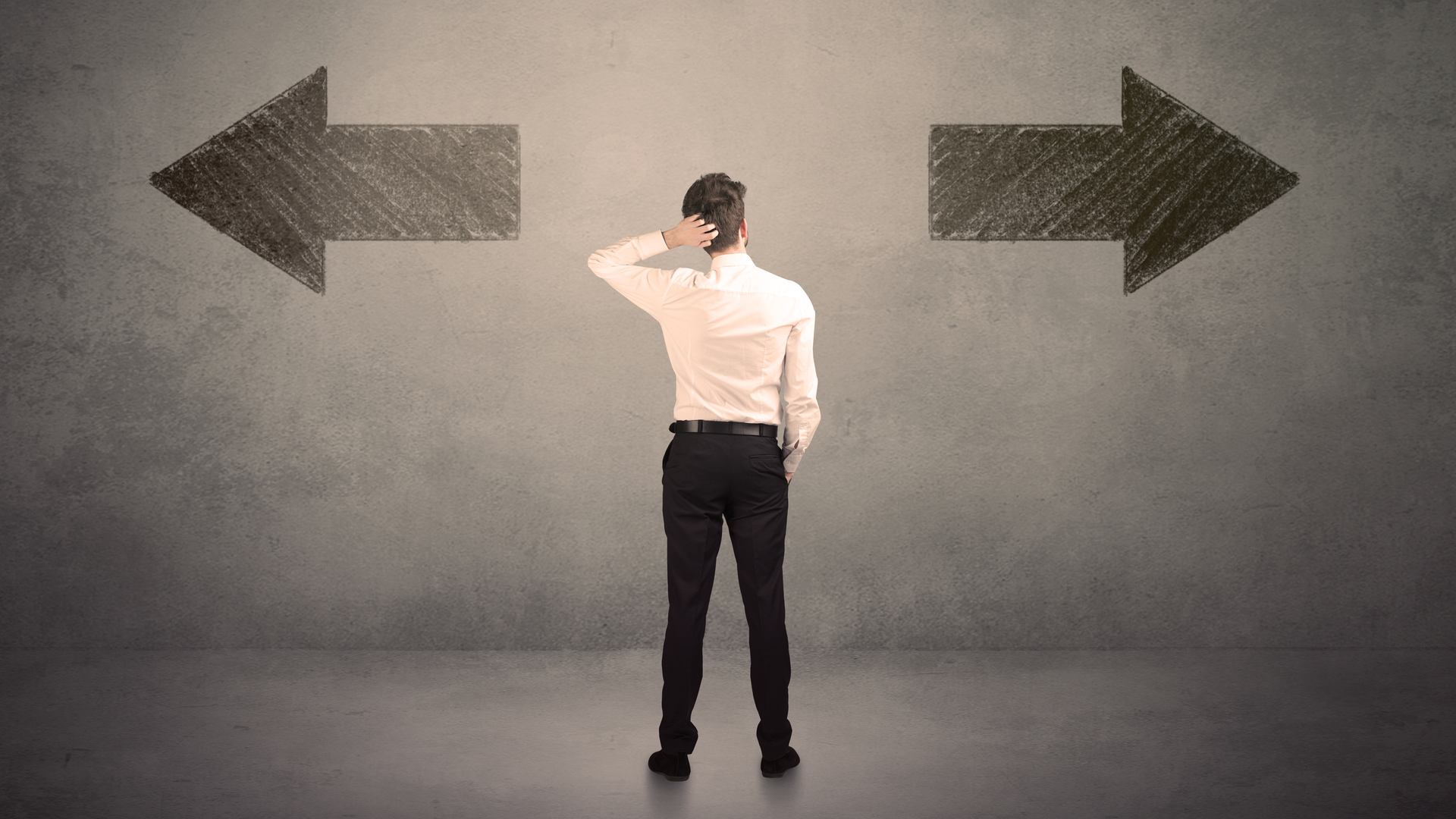 Man making decision facing arrows