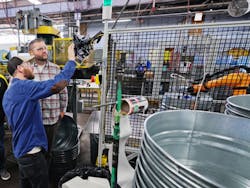 Bill Bellingham, vice president of manufacturing at Behrens (right) inspects cobot operations on the plant floor. Bill Bellingham, vice president of manufacturing at Behrens (right) inspects cobot operations on the plant floor.