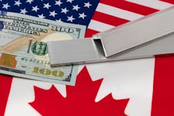 Aluminum and $100 bill on flags of USA and Canada Aluminum and $100 bill on flags of USA and Canada