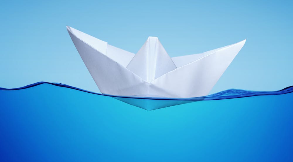 Paper toy ship on water