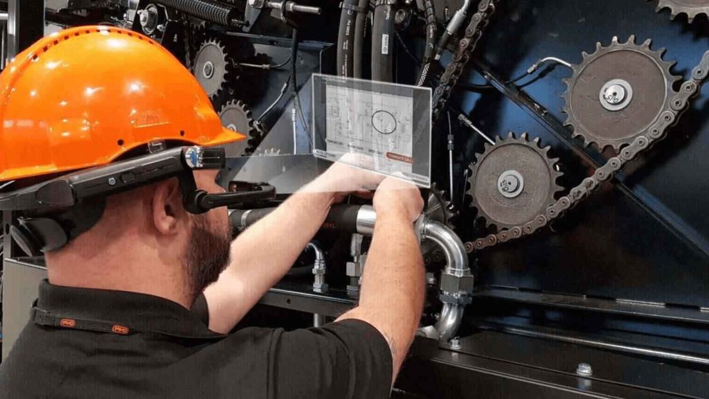 Orkel worker using RealWear HMT-1 on agriculture machine