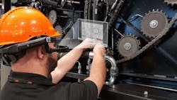 Orkel worker using RealWear HMT-1 on agriculture machine Orkel worker using RealWear HMT-1 on agriculture machine