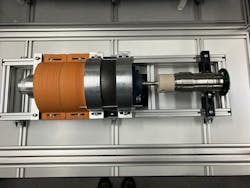 Electric machine with 3D printed parts in the middle, orange 3D printed cable cover on the left, and smart shaft as a load on the right. Electric machine with 3D printed parts in the middle, orange 3D printed cable cover on the left, and smart shaft as a load on the right.