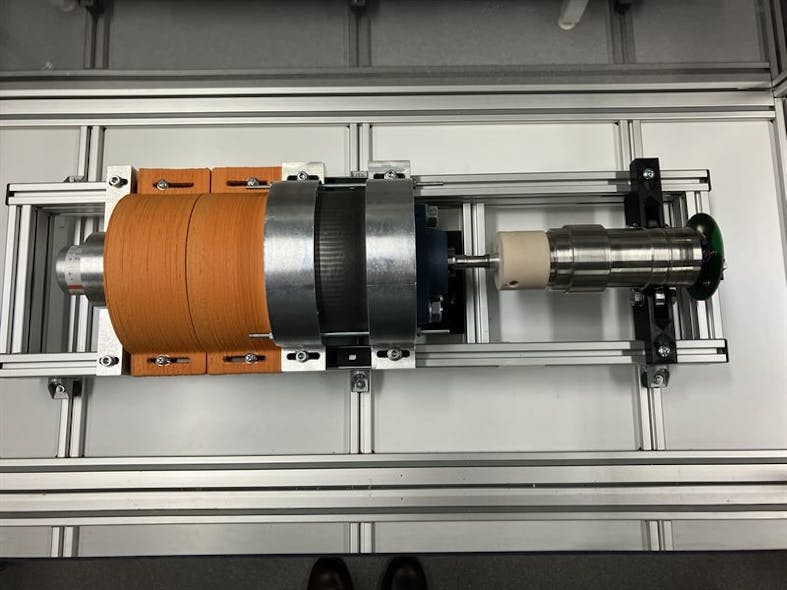 Electric machine with 3D printed parts in the middle, orange 3D printed cable cover on the left, and smart shaft as a load on the right.