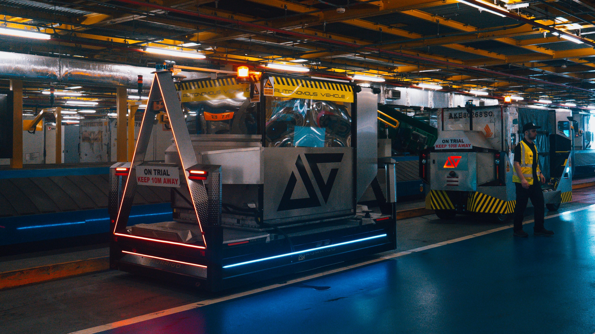 The Auto-Dolly (foreground) and Auto-DollyTug (background) operating in the baggage building at Changi Airport, Singapore.