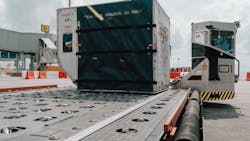 The Auto-DollyTug unloading a luggage container directly onto a Skyloader on the aircraft stand at Changi Airport, Singapore. The Auto-DollyTug unloading a luggage container directly onto a Skyloader on the aircraft stand at Changi Airport, Singapore.