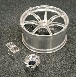 Typical components, all machined from solid aluminum, inspected by Driven Engineering on the LK CMM. Clockwise from the back: the scaled-down race car wheel, an impeller, and an aircraft fuel pump component. Typical components, all machined from solid aluminum, inspected by Driven Engineering on the LK CMM. Clockwise from the back: the scaled-down race car wheel, an impeller, and an aircraft fuel pump component.