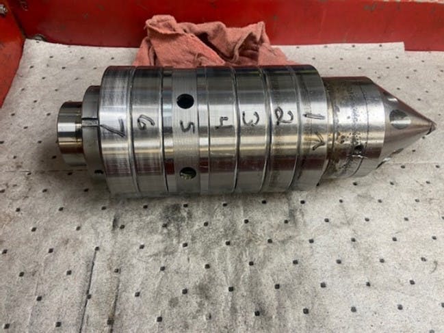 Old bearing assembly showing six bearings separate by a spacer, with replaceable nose. This is a used assembly in for repair. Old bearing assembly showing six bearings separate by a spacer, with replaceable nose. This is a used assembly in for repair.