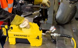 Punching holes using the Enerpac SC-Series portable hydraulic pump. Punching holes using the Enerpac SC-Series portable hydraulic pump.