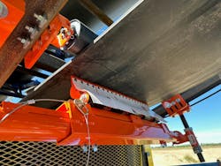 The mounting assembly firmly secures the secondary cleaner to the stringer. The mounting assembly firmly secures the secondary cleaner to the stringer.