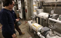 A facility manager collaborates with engineers to proactively maintain steam systems, illustrating the company's commitment to preventive maintenance and long-term efficiency gains. A facility manager collaborates with engineers to proactively maintain steam systems, illustrating the company's commitment to preventive maintenance and long-term efficiency gains.