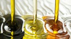 Viscous oils mixing on white surface Viscous oils mixing on white surface