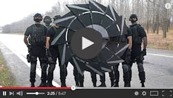 A screengrab from a YouTube video of a group of army men with a large circular blade invention in front of them A screengrab from a YouTube video of a group of army men with a large circular blade invention in front of them