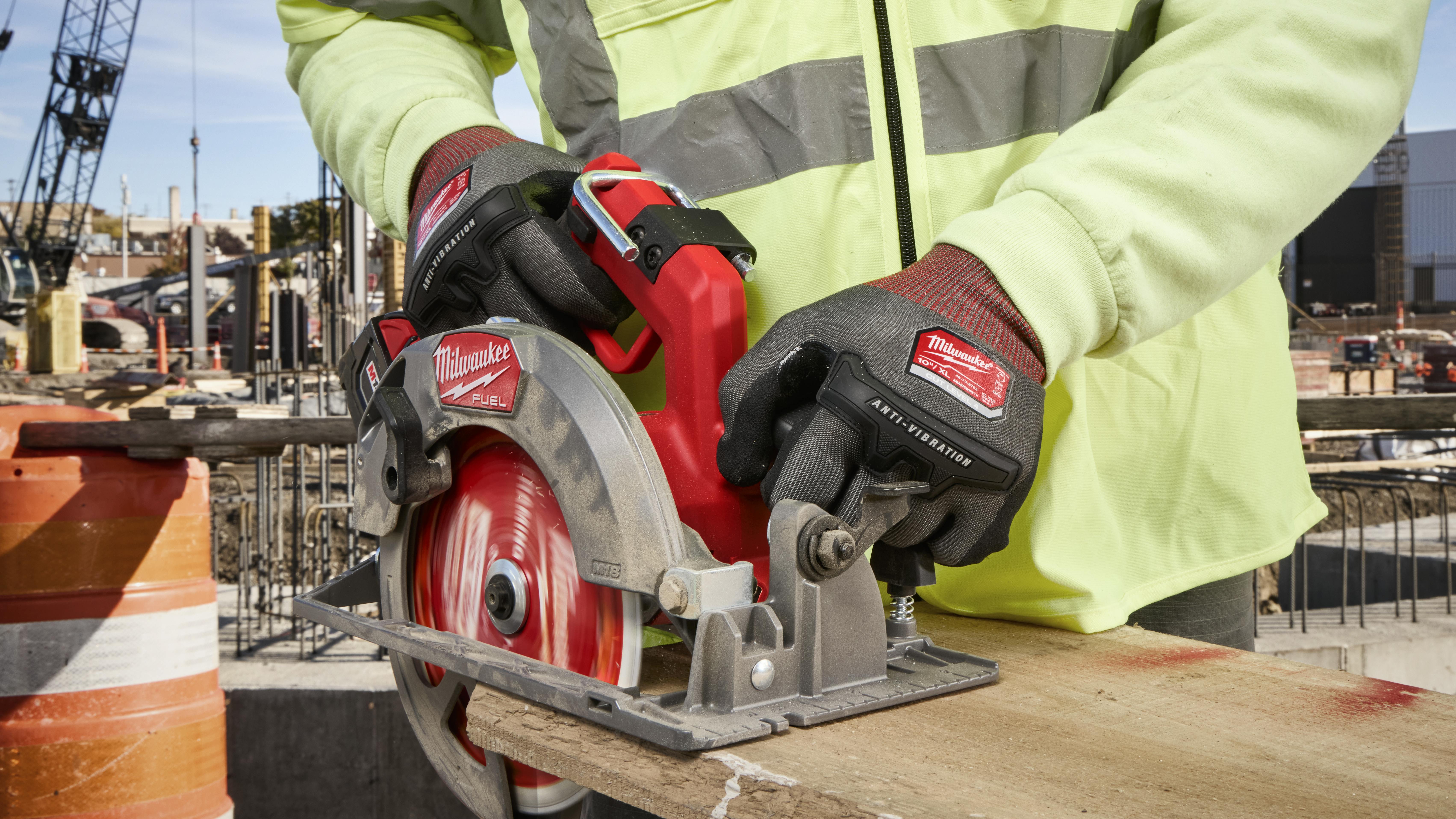 Milwaukee Tool anti-vibration gloves modeled on construction worker using a circular saw