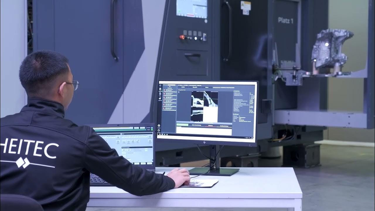 A Heitec engineer monitors a robotic CT scan and analysis system as it inspects a manufactured component.