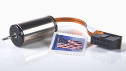 SDLM-016-032-01-01-M Direct Drive Linear Actuator against a white background with an American Forever stamp to show its made in America. SDLM-016-032-01-01-M Direct Drive Linear Actuator against a white background with an American Forever stamp to show its made in America.