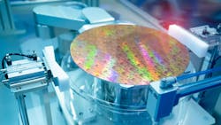 A silicon wafer being examined in a manufacturing lab. A silicon wafer being examined in a manufacturing lab.