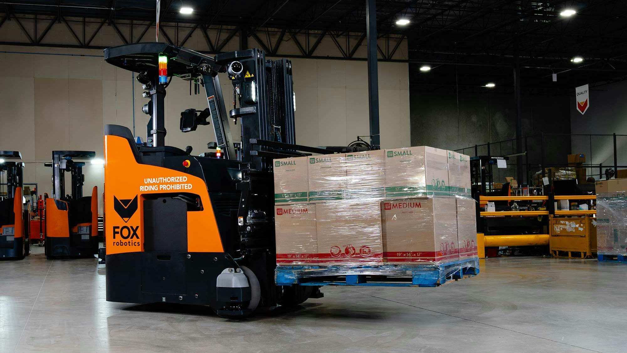Foxbot Mk3 transporting a pallet in a warehouse