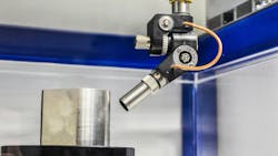 Close-up of the scanning acoustic microscopy process showing the transducer in use to inspect a metal part. Close-up of the scanning acoustic microscopy process showing the transducer in use to inspect a metal part.