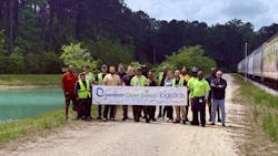 The A&R Bulk-Pak team outside holding an OCS sign that says they're OCS verified. The A&R Bulk-Pak team outside holding an OCS sign that says they're OCS verified.