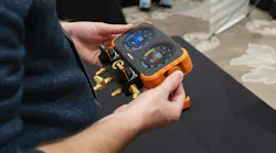 NAVAC Flex-X Manifold Gauge being held in users hands at tradeshow