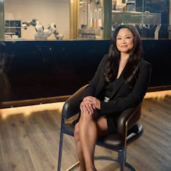 Elizaabeth Truong, BurgerBots founder, sitting in her restaurant next to ABB YuMi robot. Elizaabeth Truong, BurgerBots founder, sitting in her restaurant next to ABB YuMi robot.