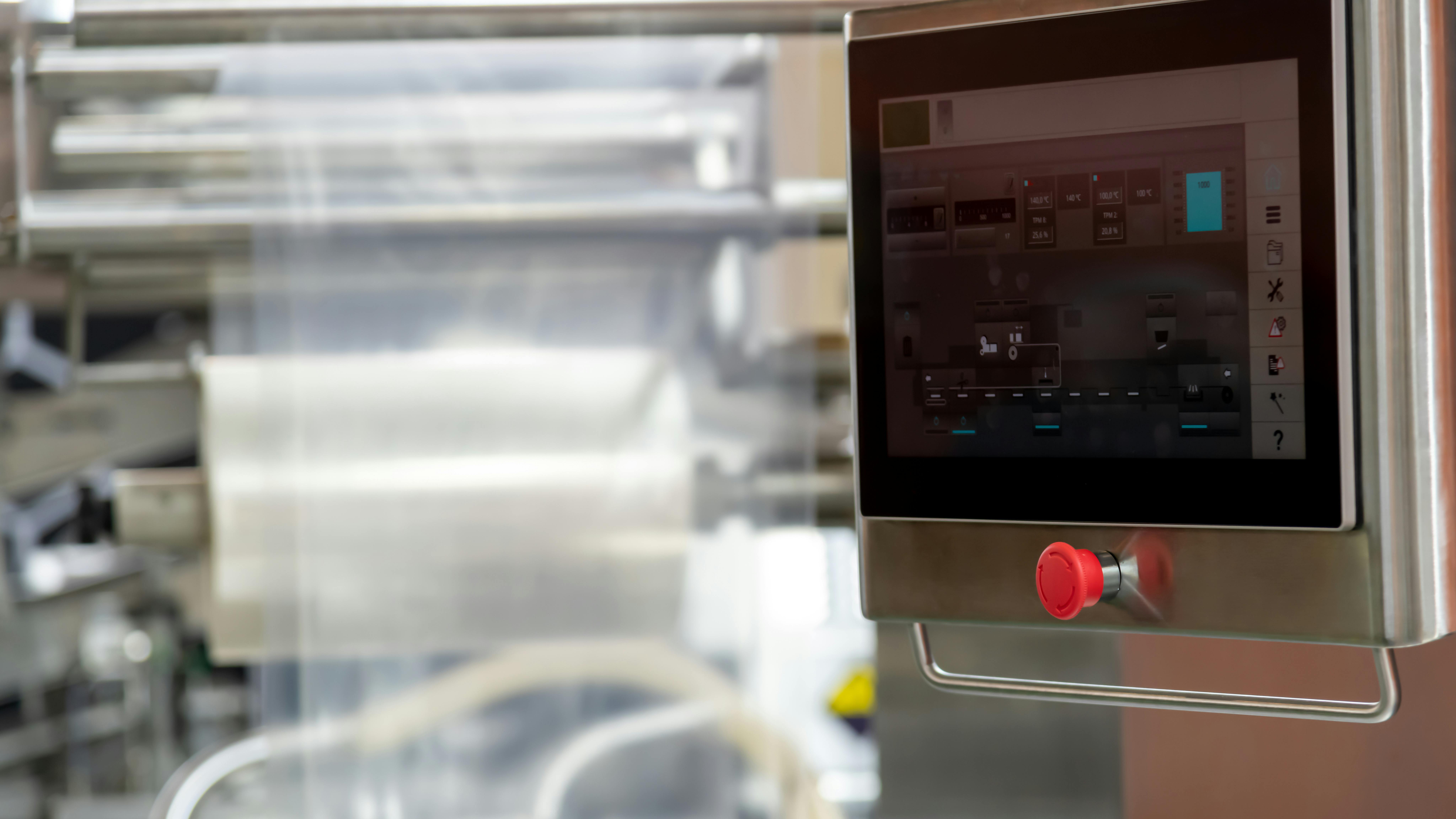 Control panel PC operates machinery in a modern manufacturing facility.