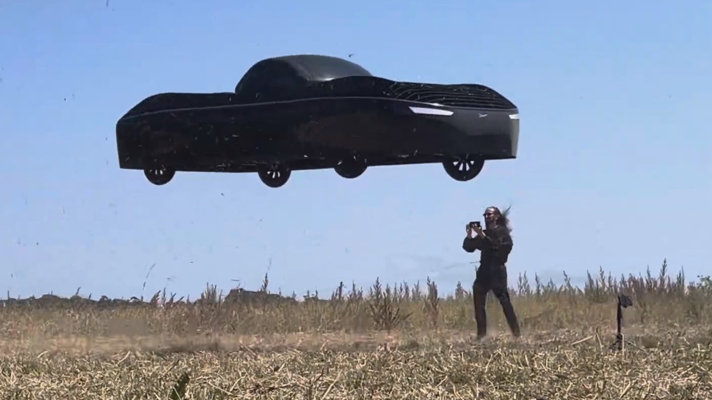 CEO Jim Dukhovny near the Model A during a test flight in a field.