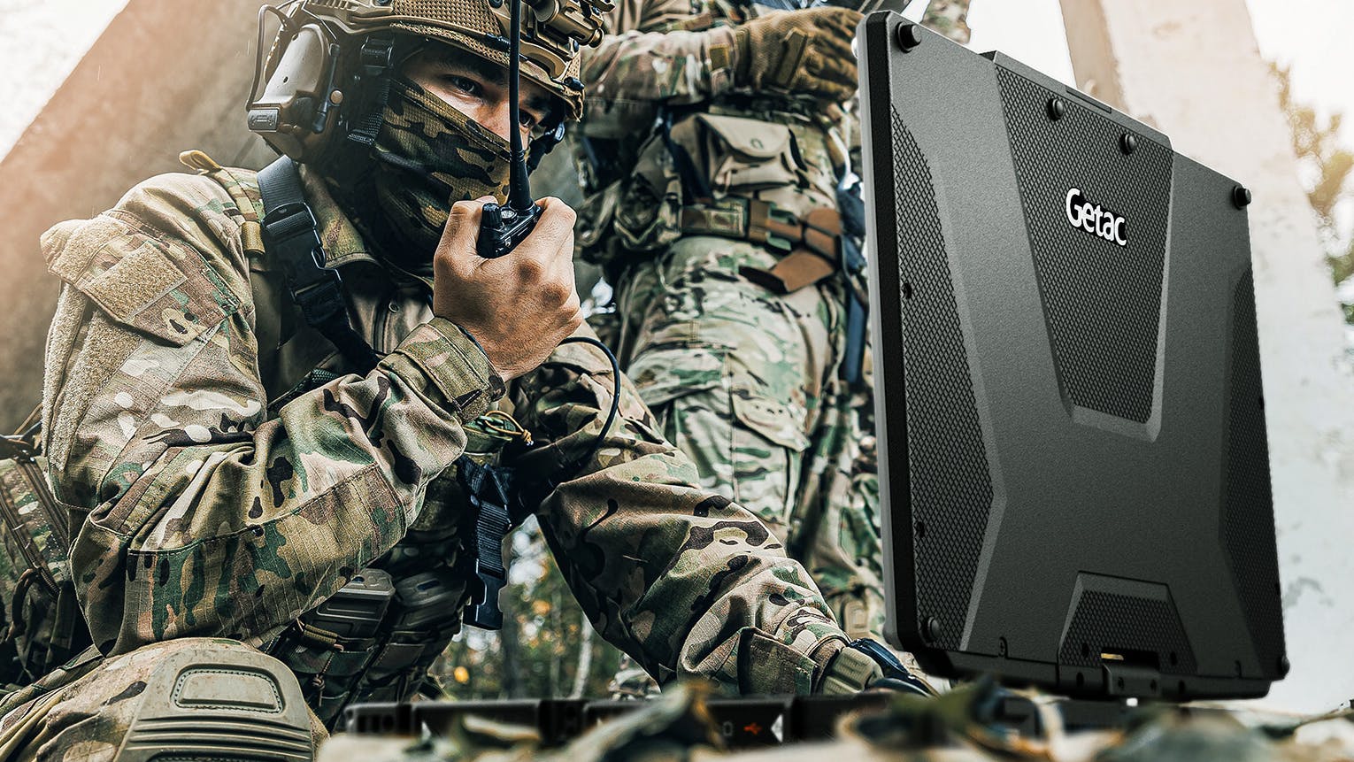 Getac Technology V120 field laptop shown in use by military professionals.