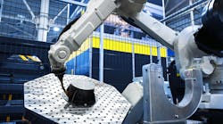 Robotic arm performs automated work on a metal part in a modern industrial factory. Robotic arm performs automated work on a metal part in a modern industrial factory.