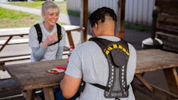 HeroWear workers eating lunch with exosuits on HeroWear workers eating lunch with exosuits on