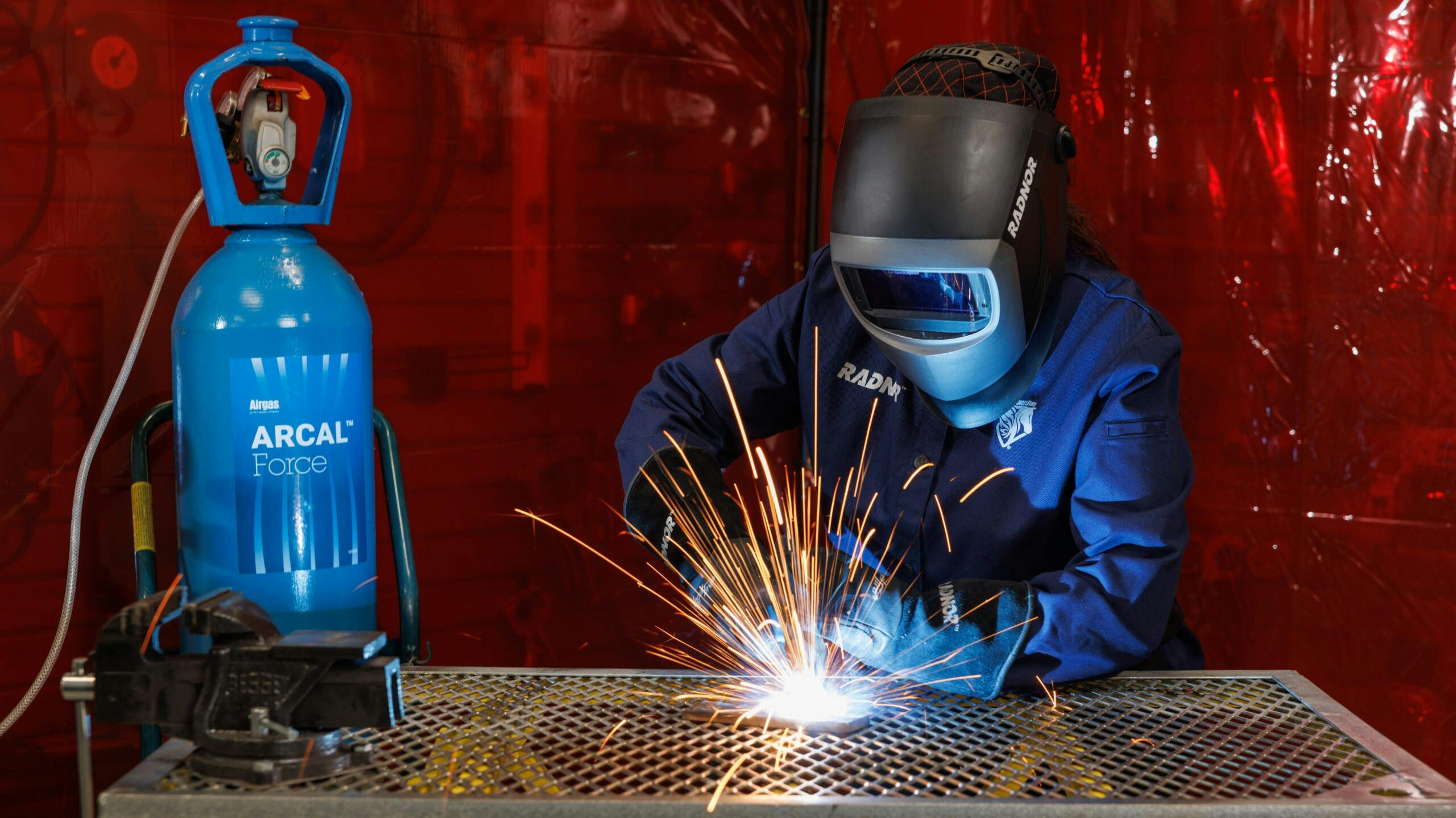 Woman welder wearing new Radnor FR clothing