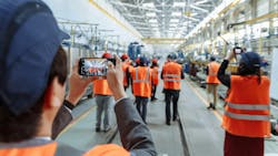 Group touring an industrial factory. Group touring an industrial factory.