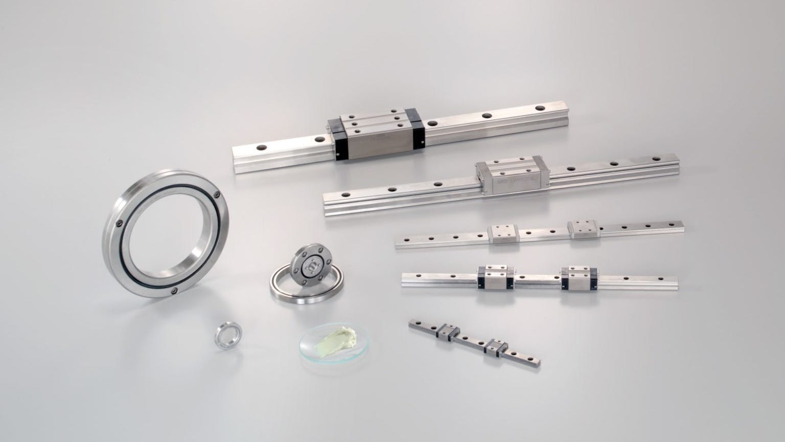 IKO Liquid Crystal Lubrication next to roller bearings and roller guides.