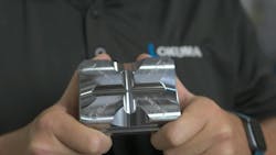 Okuma worker holding an Okuma part made with Air Turbine Technology tools. Okuma worker holding an Okuma part made with Air Turbine Technology tools.