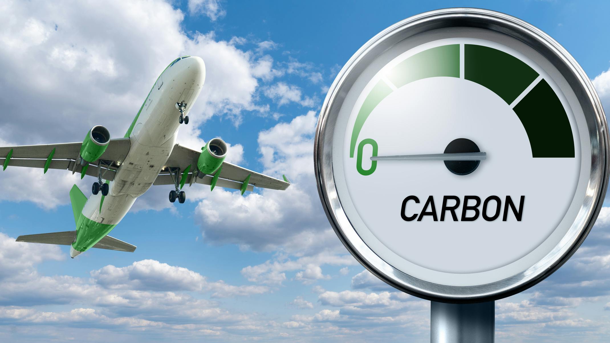 Gauge with inscription CARBON and arrow points to zero on a background of plane in sky.
