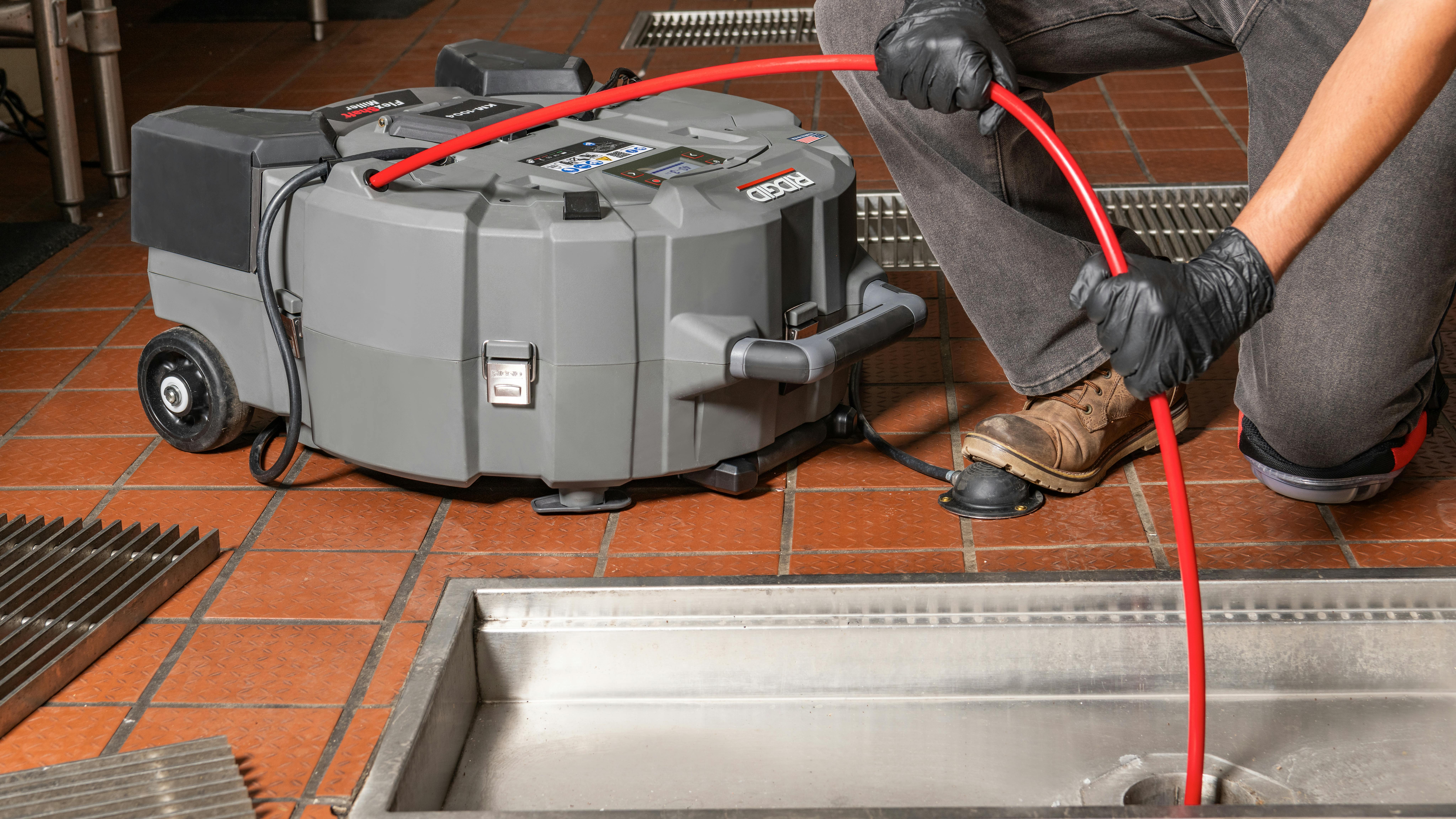 KM-1004 FlexShaft Milling Machine in a kitchen drain