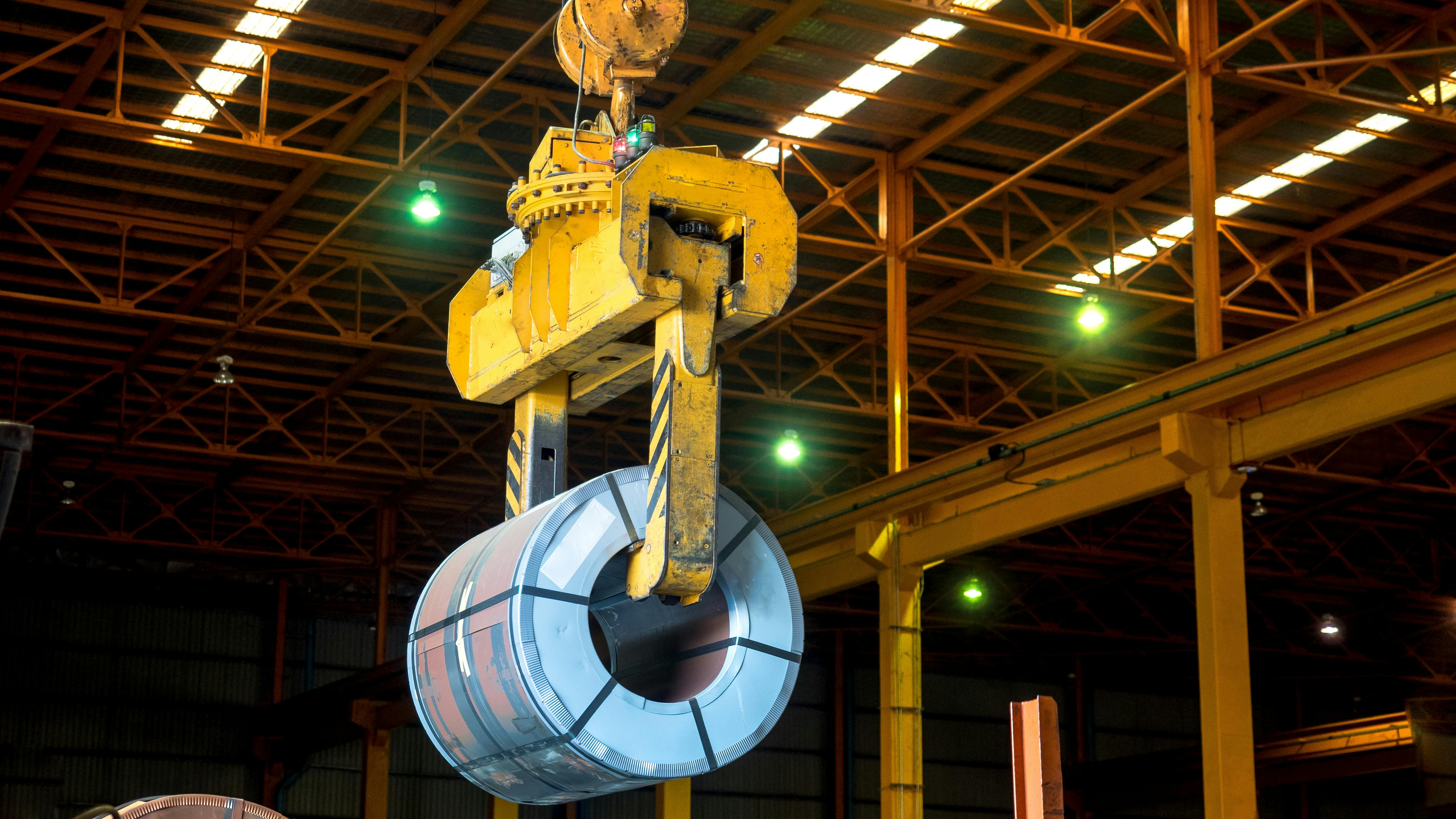 An overhead crane carrying a steel coil